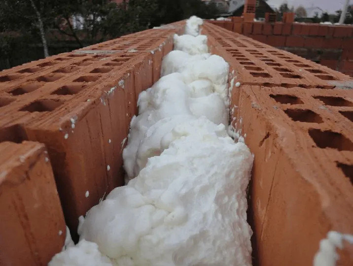 Foam in a brick wall cavity